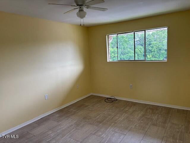 1085 Carriage Cir Unit 301, Bristol, VA 24201 - empty room with a ceiling fan and wood finished floors
