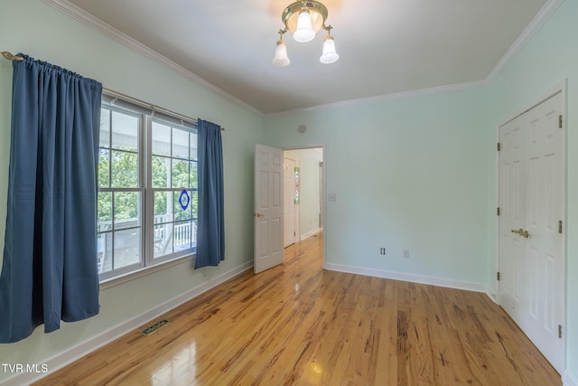 566 Beechwood Rd, Kingsport, TN 37663 - empty room featuring crown molding, a chandelier, healthy amount of natural light, and wood finished floors