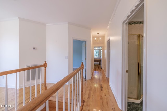 566 Beechwood Rd, Kingsport, TN 37663 - hallway featuring an upstairs landing, crown molding, light wood-type flooring, and a chandelier