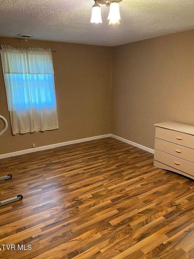 880 E Gilley Ave, Big Stone Gap, VA 24219 - unfurnished room featuring dark wood-style floors and a textured ceiling