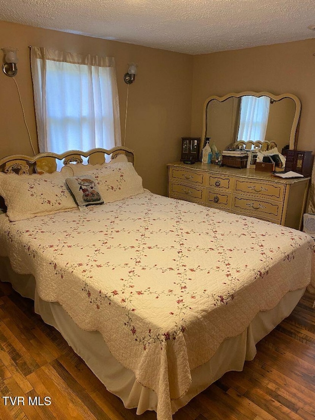 880 E Gilley Ave, Big Stone Gap, VA 24219 - bedroom featuring wood finished floors and a textured ceiling