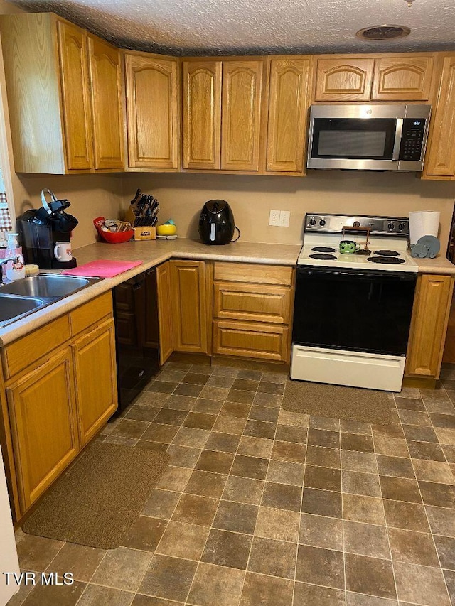 880 E Gilley Ave, Big Stone Gap, VA 24219 - kitchen featuring stainless steel microwave, electric stove, dishwasher, and light countertops