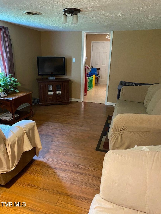 880 E Gilley Ave, Big Stone Gap, VA 24219 - living area featuring wood finished floors and a textured ceiling