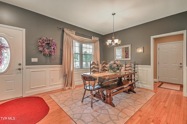 5000 Aberlea Pl, Piney Flats, TN 37686 - dining room featuring a chandelier, light wood-style floors, a wainscoted wall, and a decorative wall
