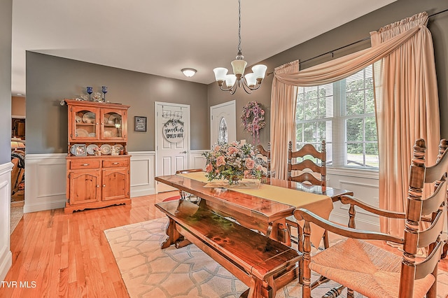 5000 Aberlea Pl, Piney Flats, TN 37686 - dining area with a chandelier, light wood-style flooring, a wainscoted wall, and a decorative wall