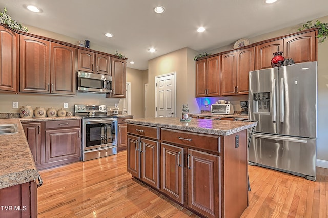 5000 Aberlea Pl, Piney Flats, TN 37686 - kitchen featuring appliances with stainless steel finishes, light wood finished floors, recessed lighting, and a center island