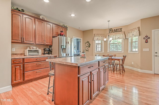 5000 Aberlea Pl, Piney Flats, TN 37686 - kitchen featuring stainless steel fridge, light wood-style floors, a center island, brown cabinets, and recessed lighting