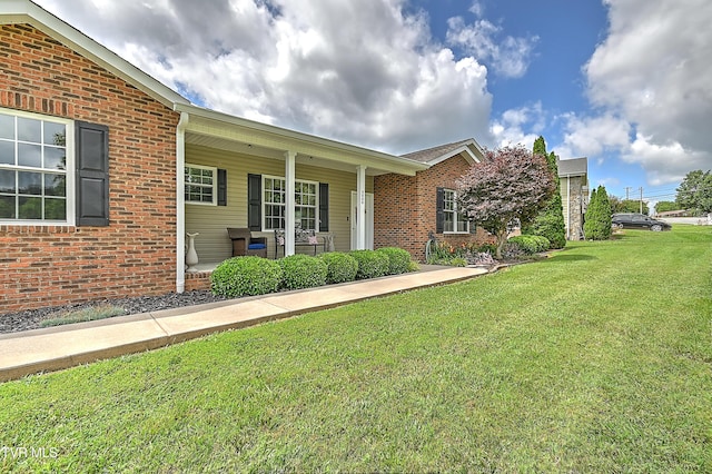 5000 Aberlea Pl, Piney Flats, TN 37686 - view of front of house featuring a front lawn, covered porch, and brick siding