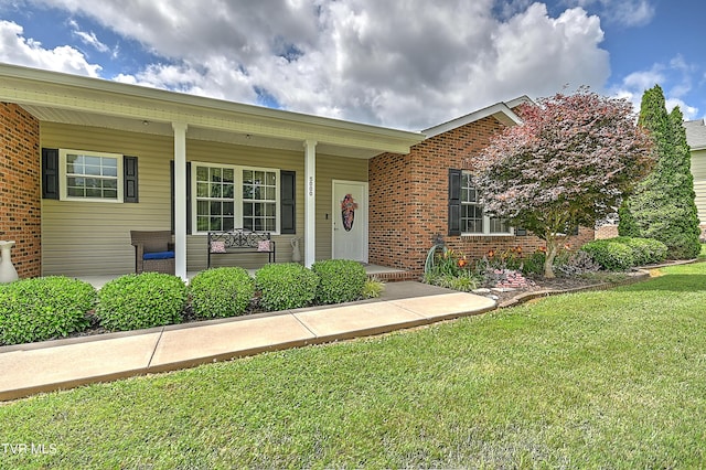 5000 Aberlea Pl, Piney Flats, TN 37686 - view of front of property with brick siding, a front yard, and covered porch