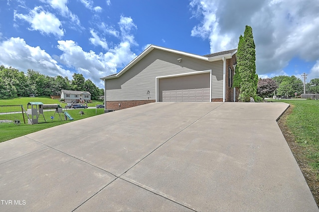 5000 Aberlea Pl, Piney Flats, TN 37686 - view of property exterior featuring a garage, a yard, brick siding, and concrete driveway