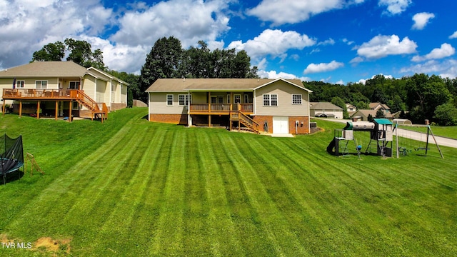5000 Aberlea Pl, Piney Flats, TN 37686 - back of property with stairs, a trampoline, and a wooden deck