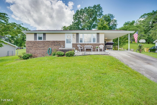221 Mcfarland Dr, Kingsport, TN 37664 - view of front facade with brick siding, asphalt driveway, a front yard, and a carport