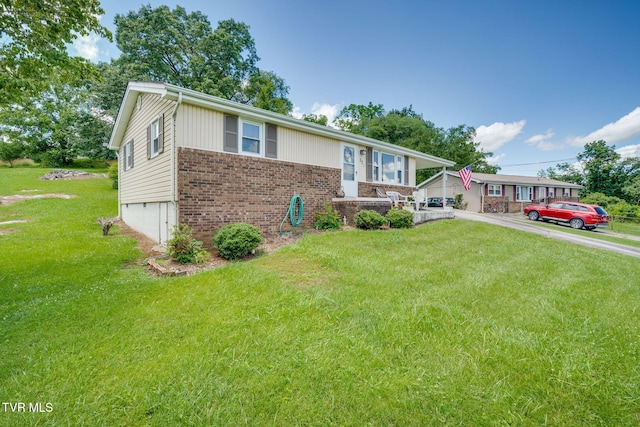 221 Mcfarland Dr, Kingsport, TN 37664 - ranch-style house featuring brick siding, a front yard, driveway, and a garage
