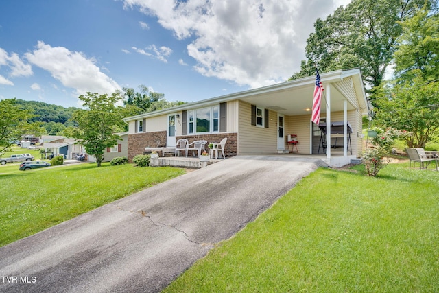 221 Mcfarland Dr, Kingsport, TN 37664 - ranch-style house featuring asphalt driveway, a front yard, brick siding, and a carport