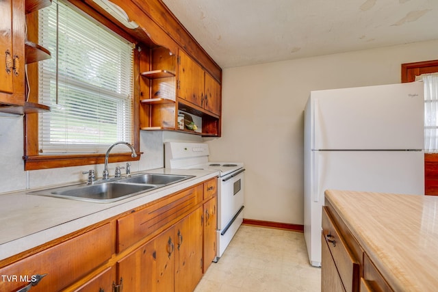 221 Mcfarland Dr, Kingsport, TN 37664 - kitchen with white appliances, open shelves, light floors, and brown cabinets