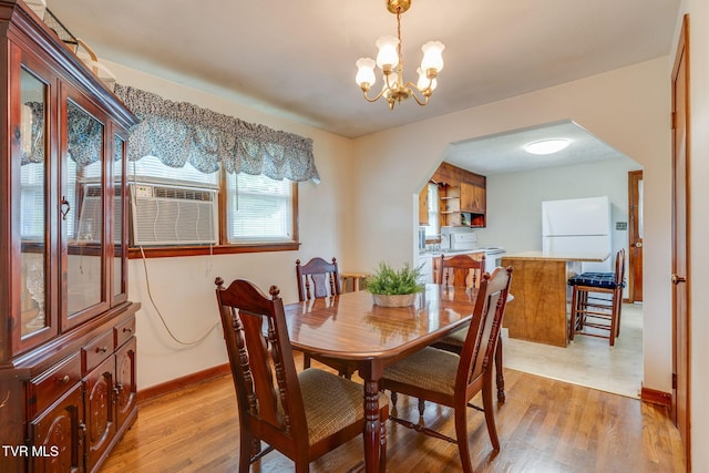 221 Mcfarland Dr, Kingsport, TN 37664 - dining space with arched walkways, a chandelier, and light wood-type flooring