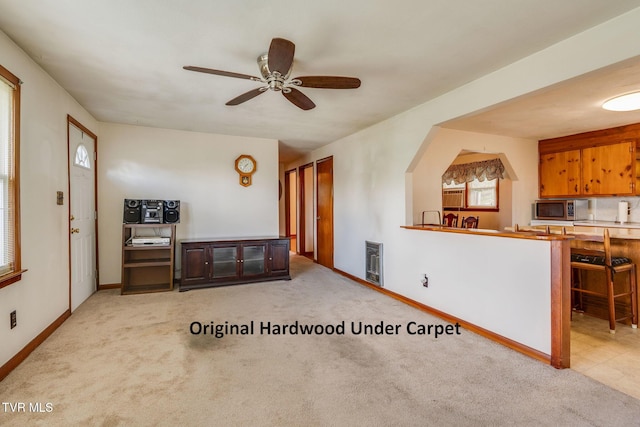 221 Mcfarland Dr, Kingsport, TN 37664 - living room featuring ceiling fan, light colored carpet, arched walkways, and heating unit