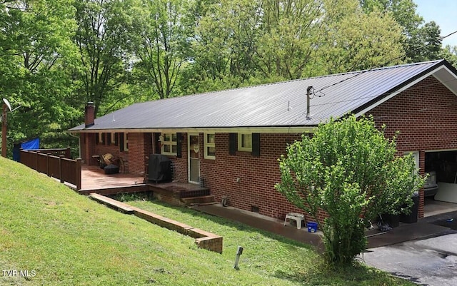 3219 Dungannon Rd, Coeburn, VA 24230 - ranch-style house with a front yard, a chimney, a metal roof, and brick siding