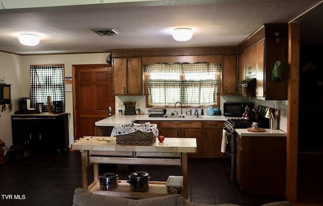 3219 Dungannon Rd, Coeburn, VA 24230 - kitchen featuring range, light countertops, dark tile patterned floors, and black microwave