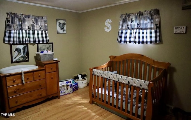 3219 Dungannon Rd, Coeburn, VA 24230 - bedroom with wood finished floors, crown molding, and a crib