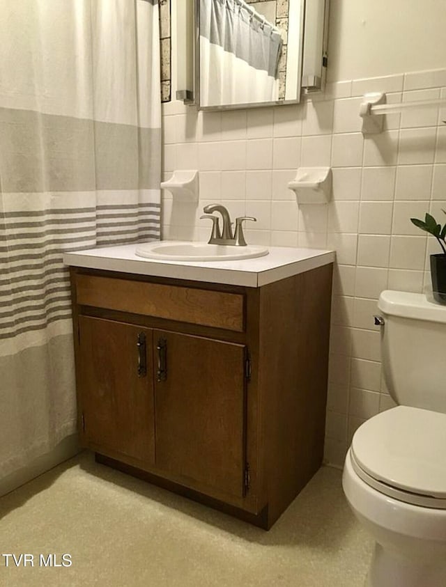 3219 Dungannon Rd, Coeburn, VA 24230 - bathroom featuring vanity, tile walls, wallpapered walls, curtained shower, and wainscoting