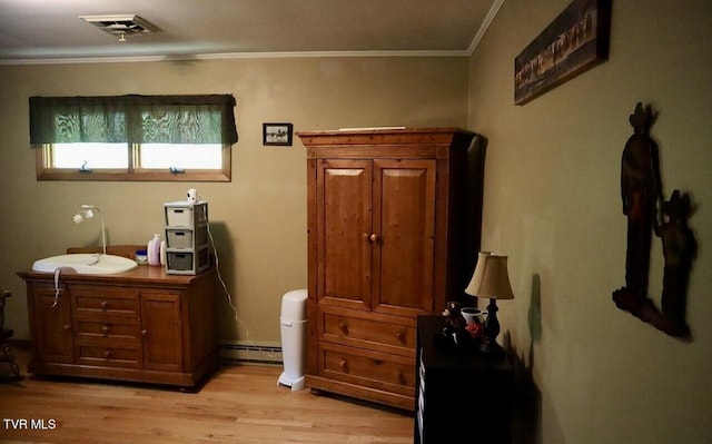 3219 Dungannon Rd, Coeburn, VA 24230 - bedroom featuring light wood-style flooring, a baseboard radiator, and crown molding