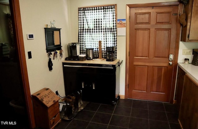 3219 Dungannon Rd, Coeburn, VA 24230 - kitchen with dark tile patterned flooring and brown cabinetry