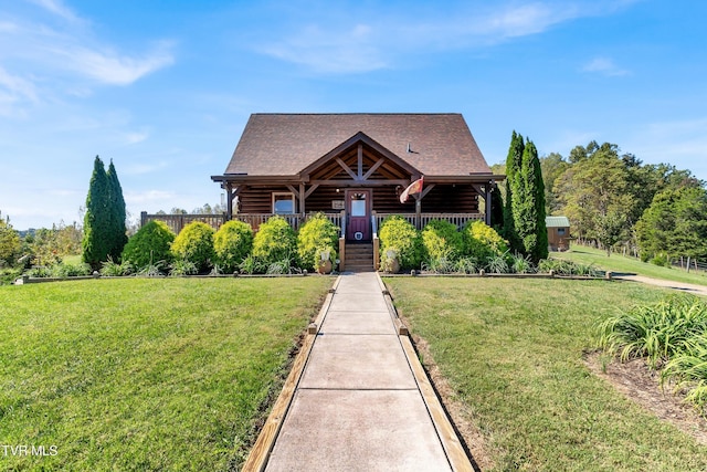 121 Hulse Rd, Jonesborough, TN 37659 - log cabin featuring a front yard, covered porch, log exterior, and roof with shingles