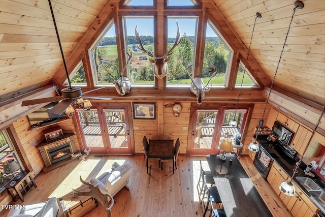 121 Hulse Rd, Jonesborough, TN 37659 - living room with wood ceiling, wooden walls, high vaulted ceiling, light wood finished floors, and a glass covered fireplace