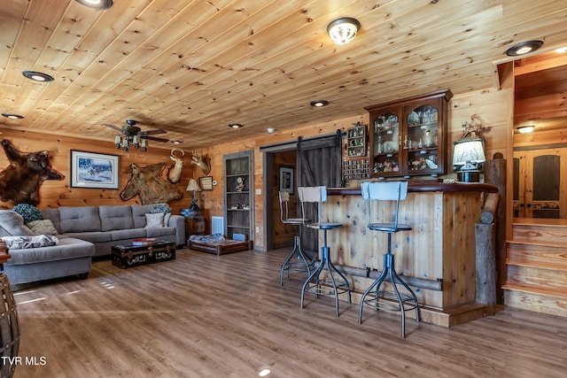 121 Hulse Rd, Jonesborough, TN 37659 - living room with wood finished floors, a barn door, ceiling fan, wooden walls, and wooden ceiling