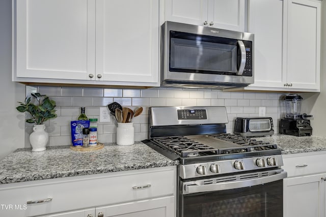 194 Wanderlust Ct, Johnson City, TN 37604 - kitchen featuring appliances with stainless steel finishes, white cabinets, and tasteful backsplash