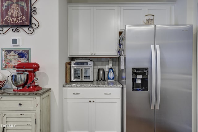 194 Wanderlust Ct, Johnson City, TN 37604 - kitchen with stainless steel fridge with ice dispenser, white cabinets, light stone countertops, and tasteful backsplash