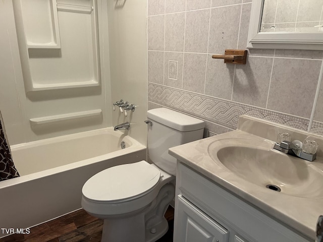 505 NE Lake St, Wise, VA 24293 - bathroom featuring vanity, shower / bath combo with shower curtain, tile walls, tasteful backsplash, and wood finished floors