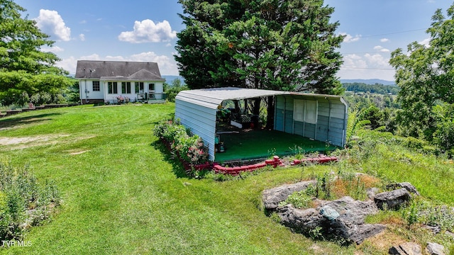 124 Maple Crest Cir, Surgoinsville, TN 37873 - view of green lawn featuring a detached carport