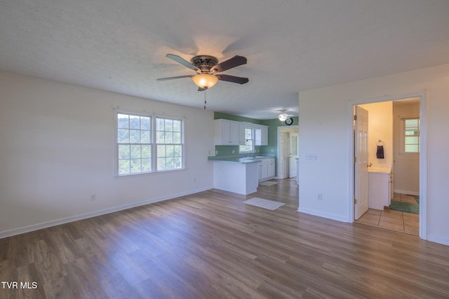 124 Maple Crest Cir, Surgoinsville, TN 37873 - unfurnished living room featuring a ceiling fan and wood finished floors