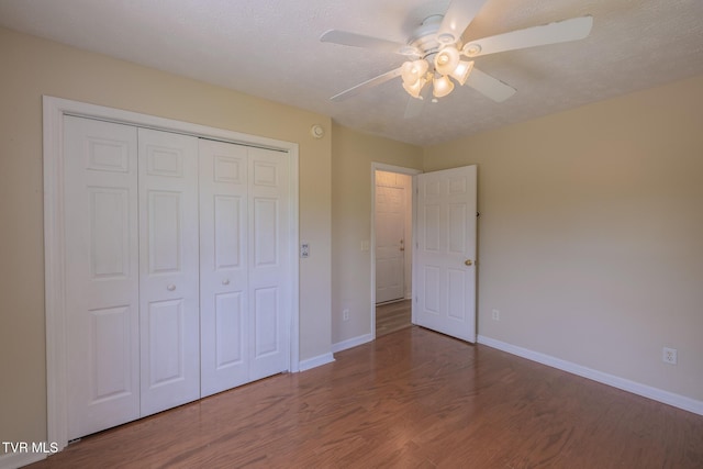 124 Maple Crest Cir, Surgoinsville, TN 37873 - unfurnished bedroom featuring wood finished floors, a closet, and a ceiling fan