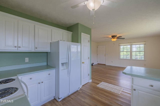 124 Maple Crest Cir, Surgoinsville, TN 37873 - kitchen featuring white appliances, ceiling fan, wood finished floors, white cabinets, and a textured ceiling