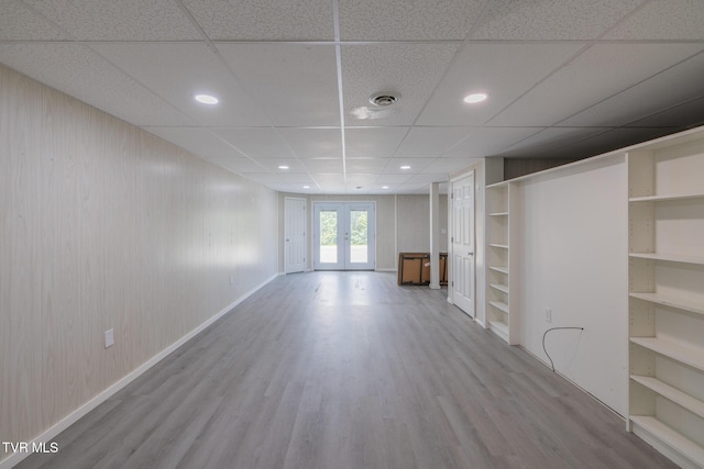 124 Maple Crest Cir, Surgoinsville, TN 37873 - unfurnished living room featuring wood finished floors, french doors, a paneled ceiling, wood walls, and recessed lighting