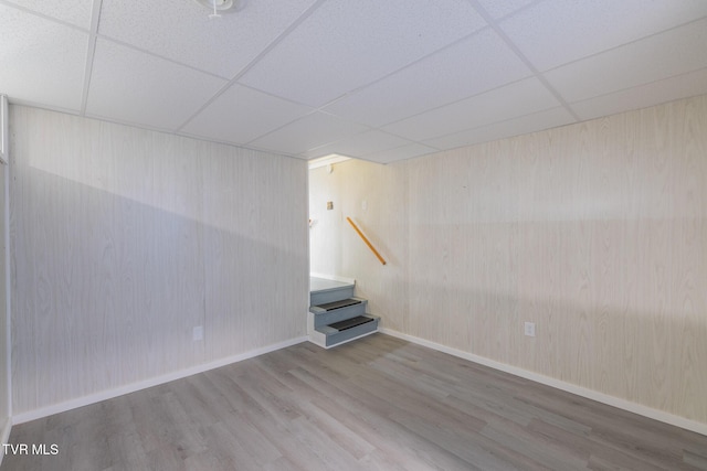 124 Maple Crest Cir, Surgoinsville, TN 37873 - spare room with wood finished floors, a paneled ceiling, wood walls, and stairs