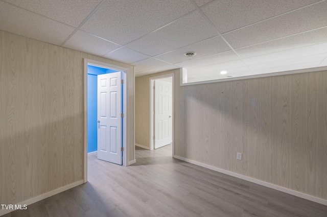 124 Maple Crest Cir, Surgoinsville, TN 37873 - empty room featuring a drop ceiling, wood finished floors, and wood walls