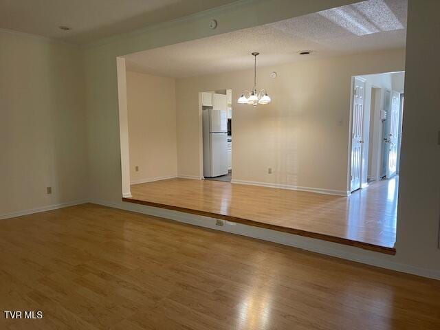 1203 E 8th Ave Unit 3, Johnson City, TN 37601 - spare room with a chandelier and light wood-type flooring