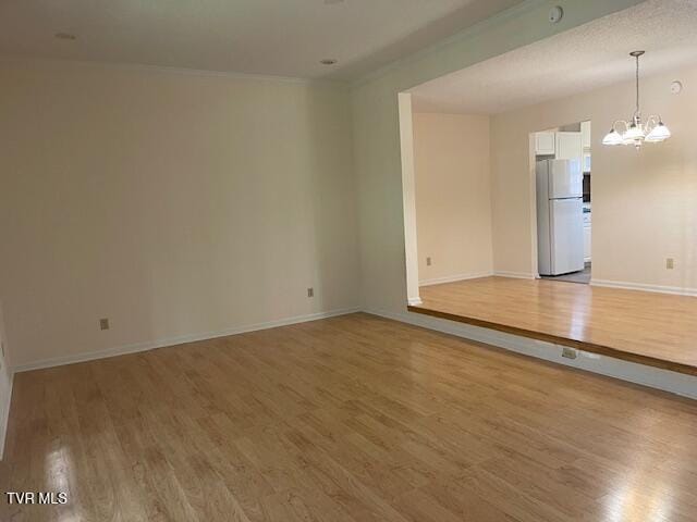 1203 E 8th Ave Unit 3, Johnson City, TN 37601 - spare room featuring a chandelier and light wood finished floors