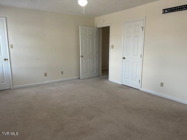 1203 E 8th Ave Unit 3, Johnson City, TN 37601 - unfurnished bedroom featuring carpet floors and a textured ceiling