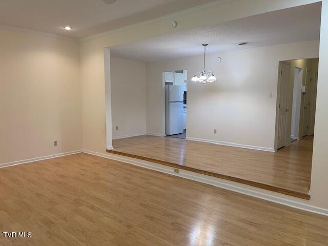 1203 E 8th Ave Unit 3, Johnson City, TN 37601 - spare room featuring a chandelier, light wood-style flooring, and recessed lighting
