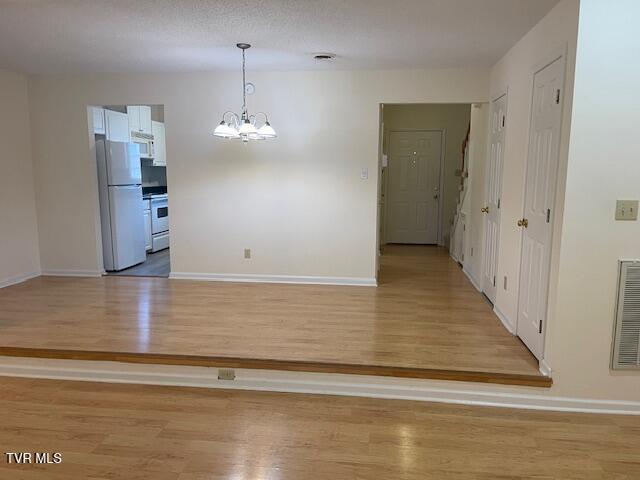1203 E 8th Ave Unit 3, Johnson City, TN 37601 - unfurnished dining area with a chandelier and light wood-style floors