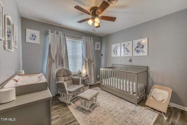 103 Daniels Way, Johnson City, TN 37615 - bedroom with wood finished floors, a nursery area, and ceiling fan