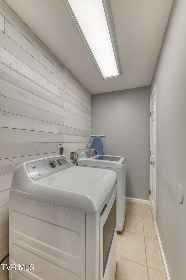 103 Daniels Way, Johnson City, TN 37615 - washroom featuring washing machine and clothes dryer, wooden walls, and light tile patterned floors
