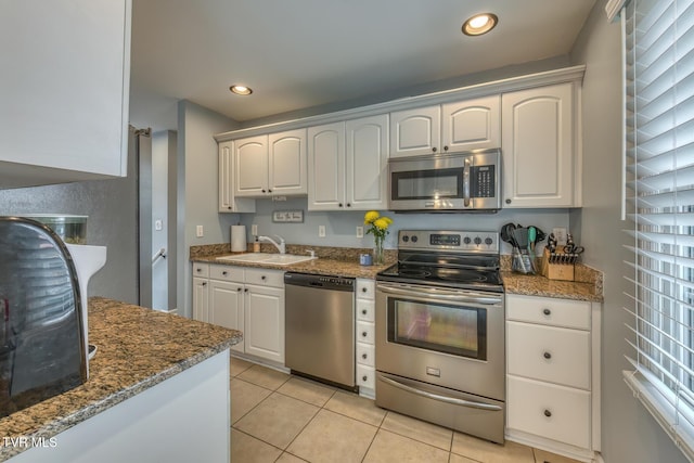 103 Daniels Way, Johnson City, TN 37615 - kitchen featuring stainless steel appliances, light tile patterned flooring, dark stone counters, white cabinetry, and recessed lighting