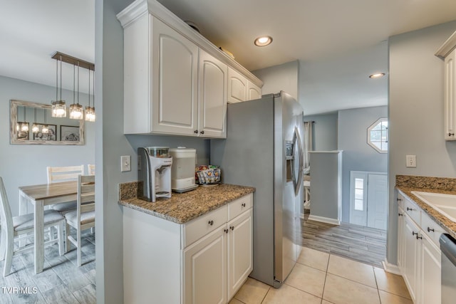 103 Daniels Way, Johnson City, TN 37615 - kitchen featuring stainless steel appliances, light tile patterned floors, light stone counters, recessed lighting, and white cabinetry