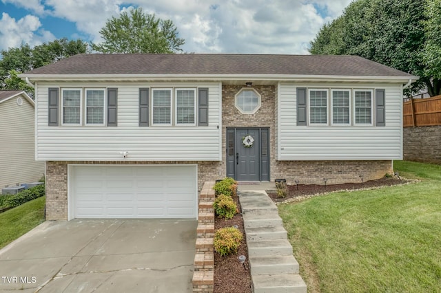 103 Daniels Way, Johnson City, TN 37615 - bi-level home featuring brick siding, concrete driveway, and a garage